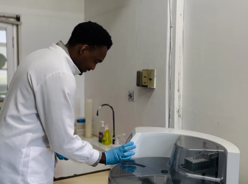 NHRTI laboratory scientist operating laboratory equipment