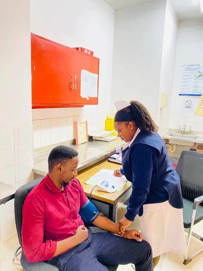 NHRTI nurse checking a patient’s blood pressure