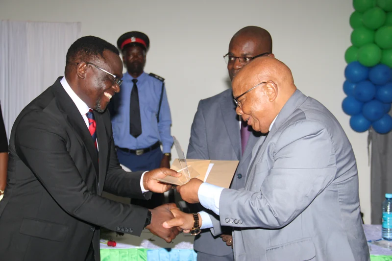 NHRTI first Director Prof. Njelesani receiving an award for Distinguished Service in Health Research and Training