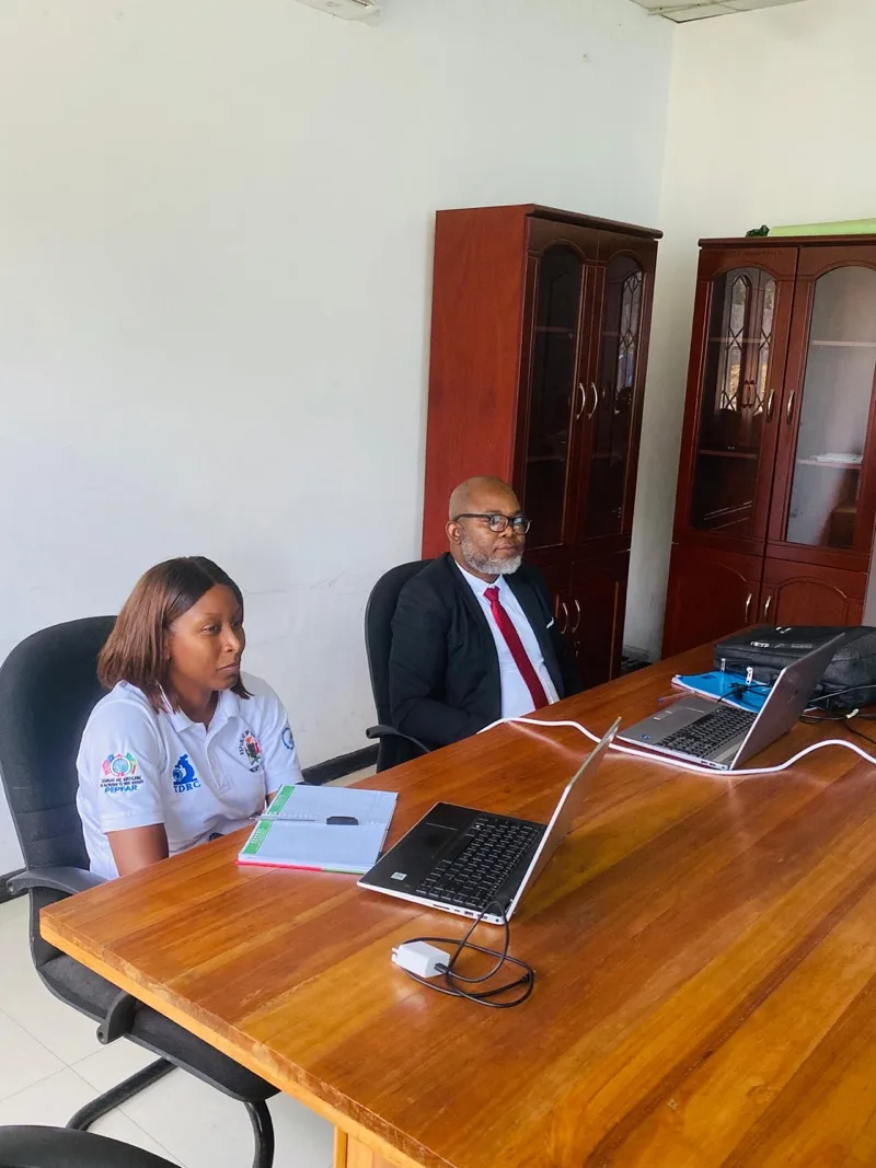 NHRTI quality management officers conducting a technical review meeting with laptops and documentation