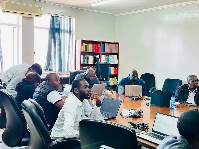 Participants working with laptops during a research training workshop